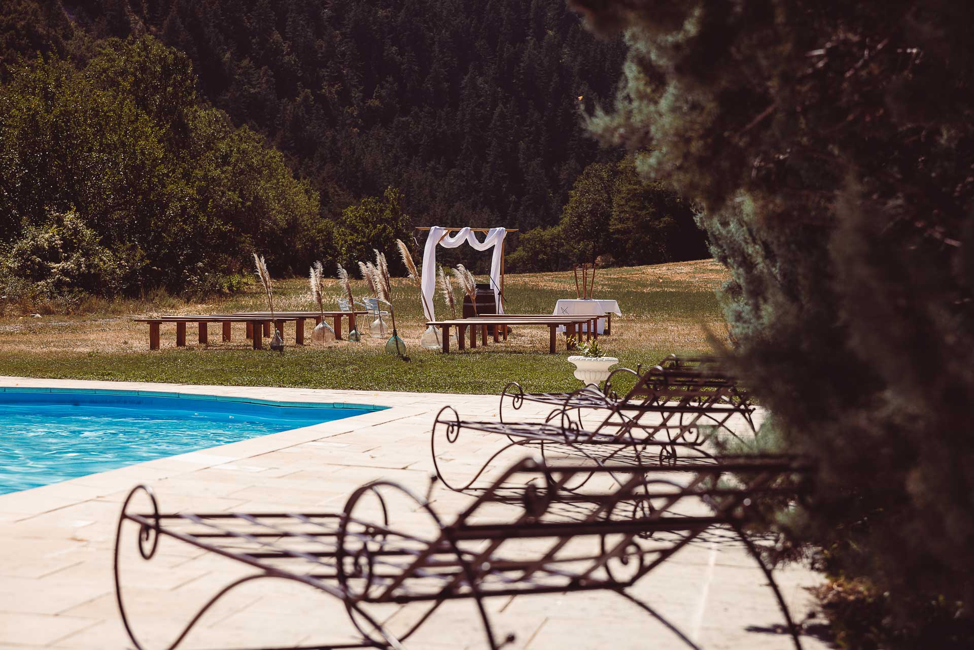 Outdoor boho ceremony arch by the pool, Provence mountains