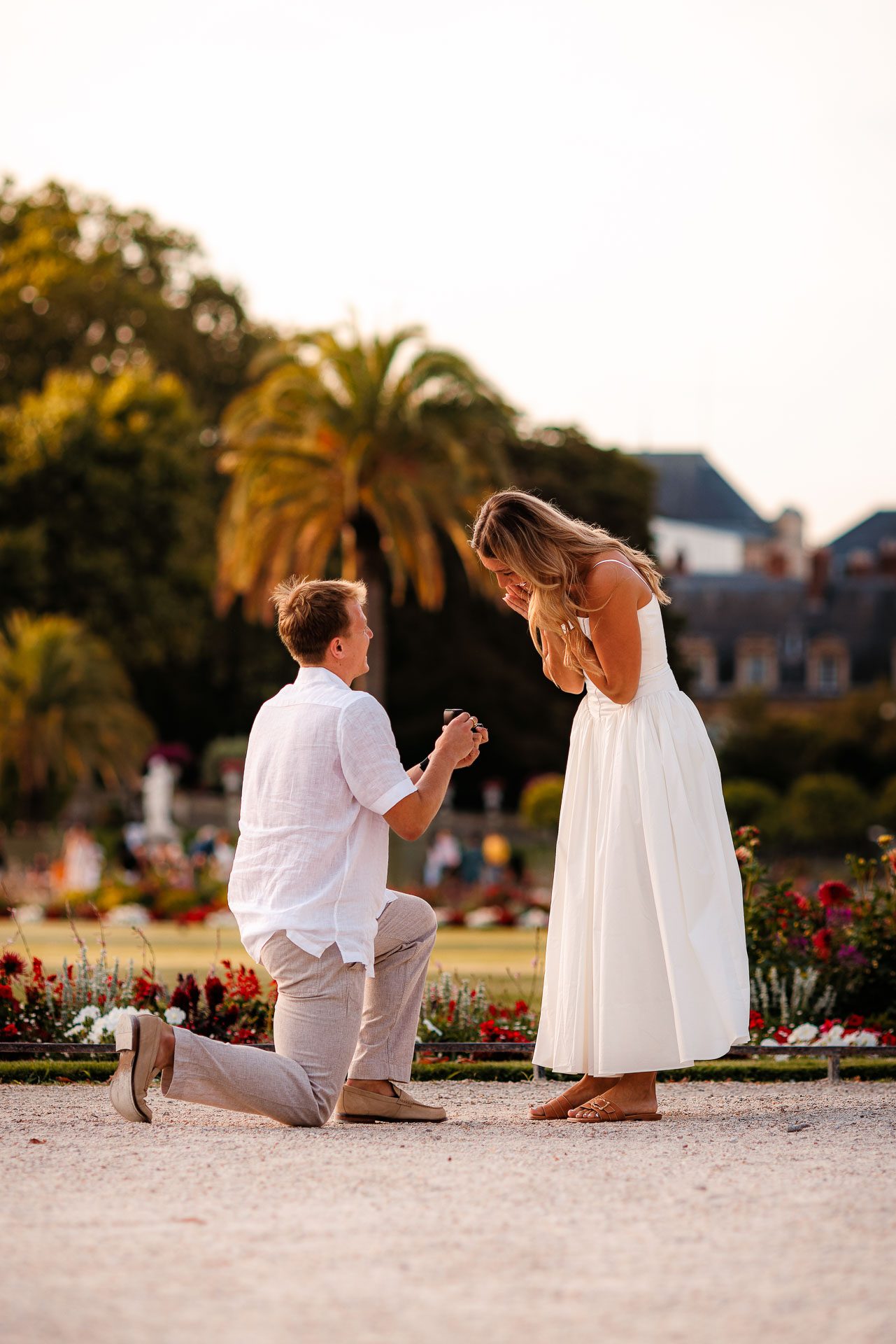 Groom-to-be on one knee proposing to Maycey at the Jardin du Luxembourg, Paris 2024