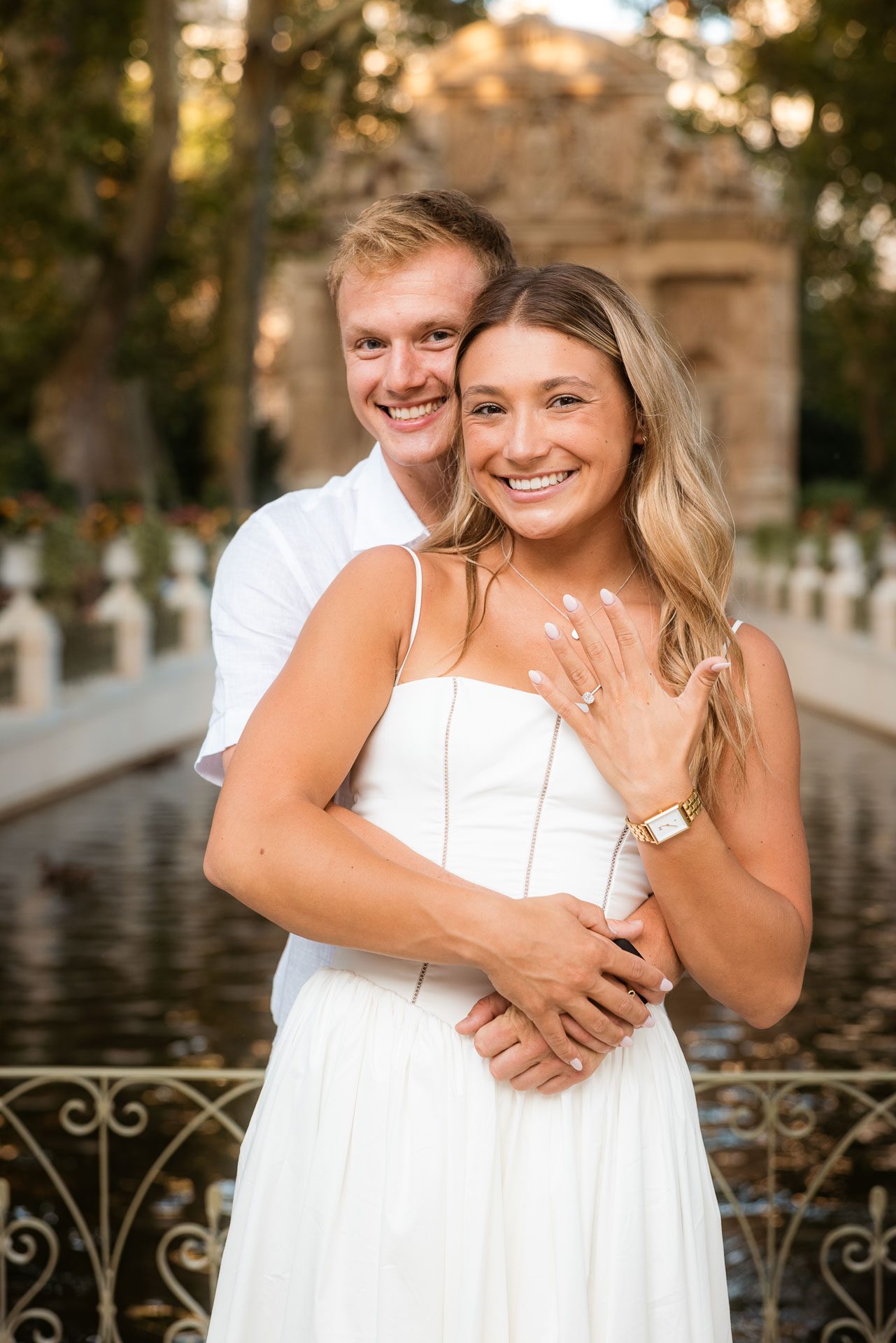 Newly engaged couple showing the ring at the Medici Fountain, Paris