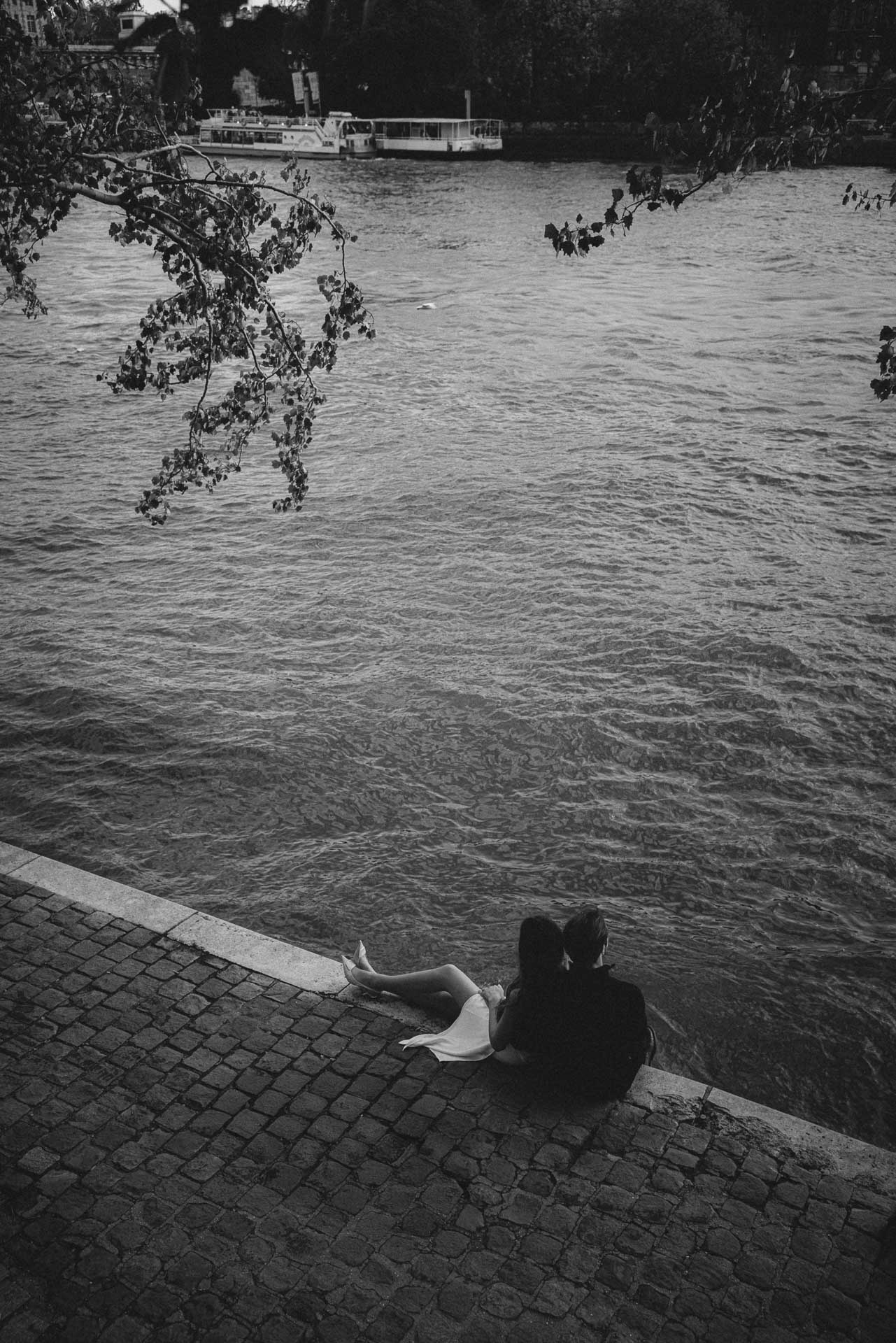 Couple embracing against a stone wall in Paris