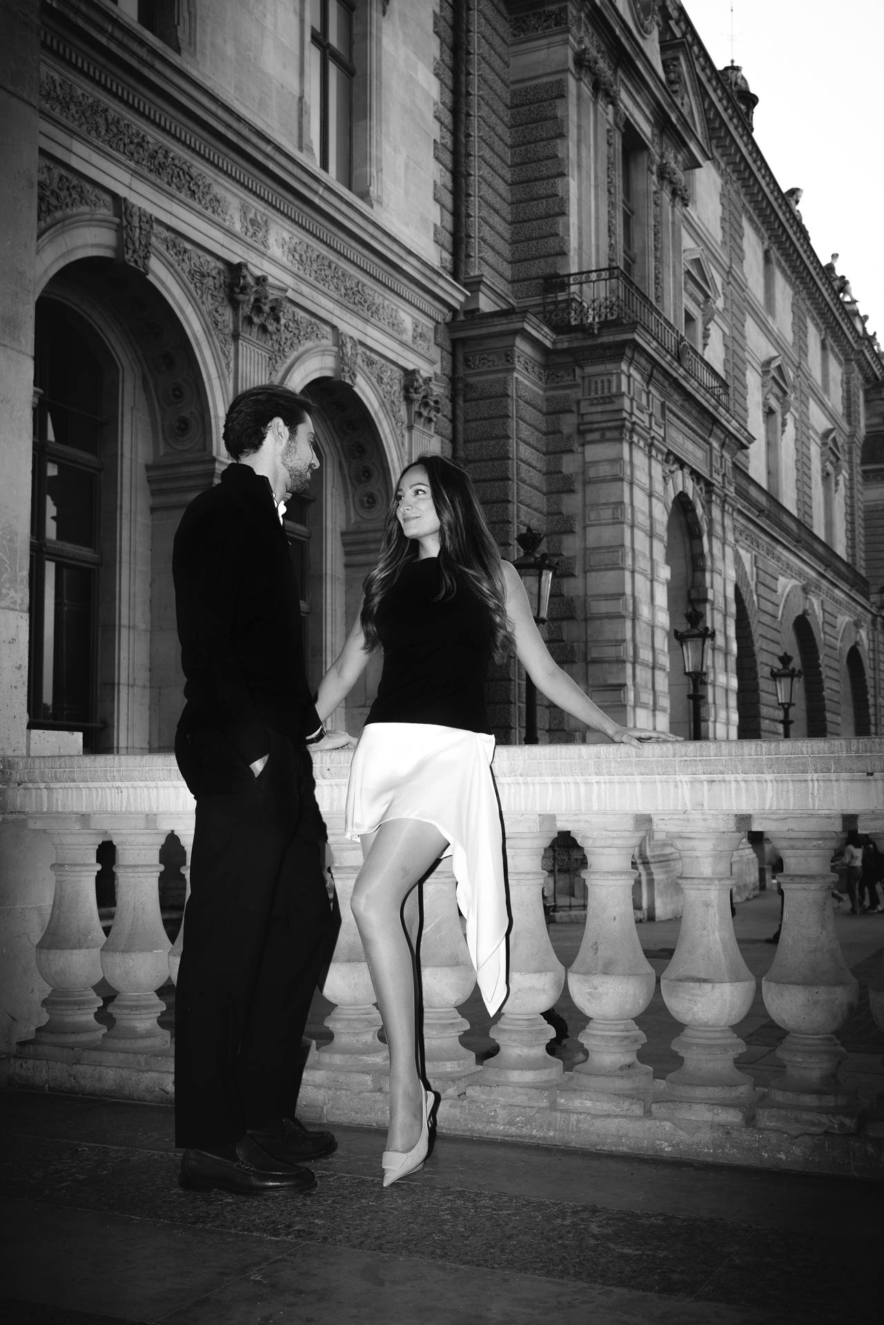 Elegant engagement portrait on the steps of a Parisian palace