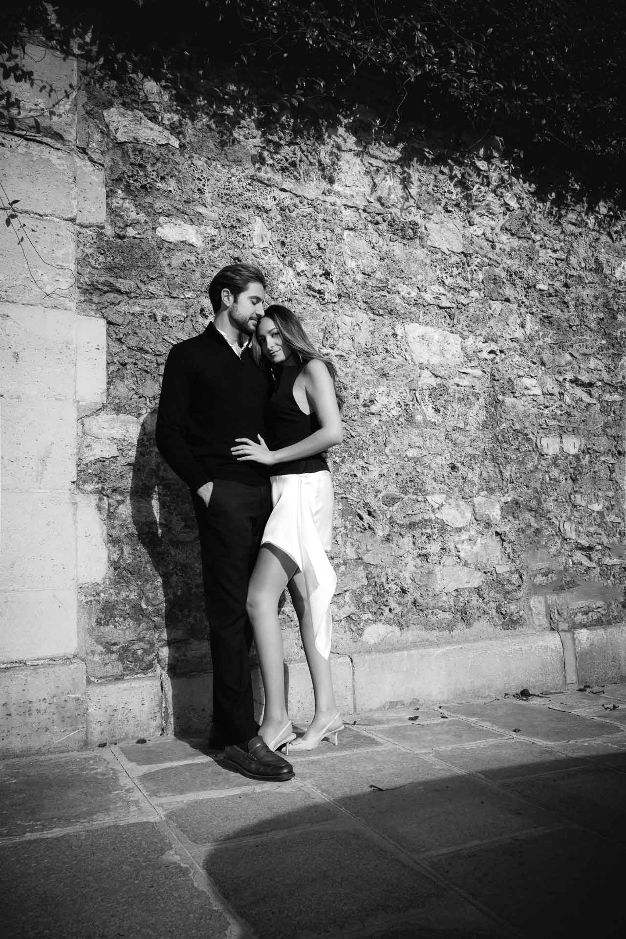 Couple walking along the Seine cobblestones at golden hour